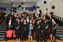 Uxbridge College and Harrow College HNC & HND achievers celebrate their graduation at Brunel University London with the traditional custom of throwing their mortar boards in the air.