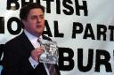 Nick Griffin leader of the BNP at a rally in Blackburn this month where he holds up a leaflet stating ‘Islam is a threat to us all’