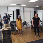 Hairdressing student Brogan Hollyoak, far right, was one of students and staff featured in a Government film encouraging the UK's school and college students to return on site
