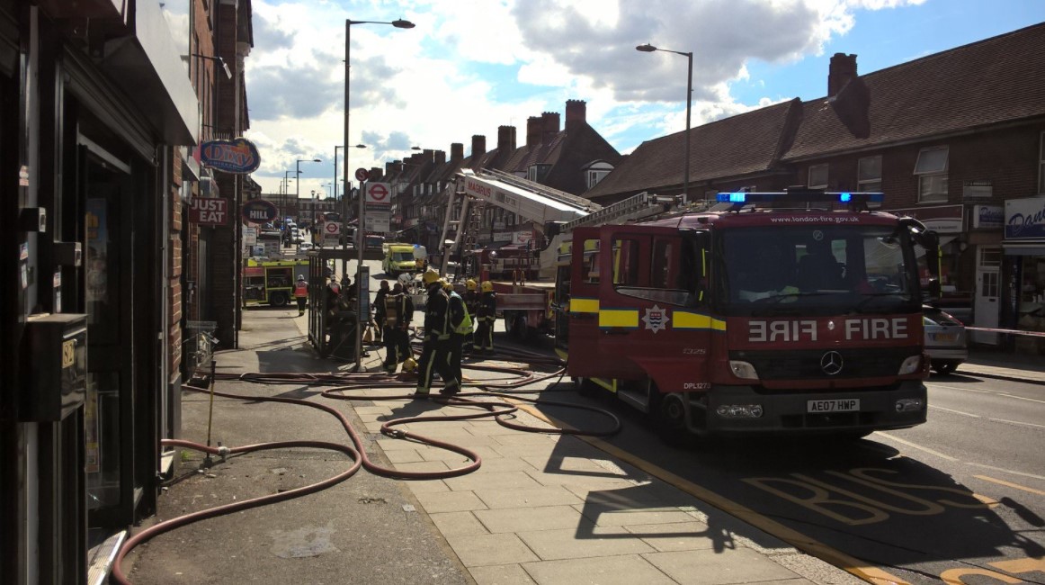Man taken to hospital and hundreds evacuated from shops and homes after huge fire in workshop
