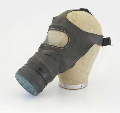 World War II civilian gasmask in a cardboard carrying case labelled Mary Berry - 1 Court Orchard.
Gas was used in World War I, killing and injuring many soldiers. Before World War II started everyone in Britain was given a gas mask.