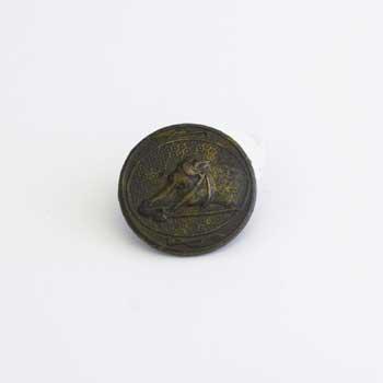 Brass button depicting a horse's head (as if racing) and whips around the border. Reverse reads 'Neat and modern sporting designs. Septr 1st 1841'. In the 18th century buttons were covered with a thin layer of gold leaf.