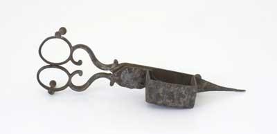 Victorian wick trimmer and snuffer with ornate handles. Trimming the wick at regular intervals (or before each burn) helped candles to be consumed evenly, thus extending the burning time. Candles were an important source of lighting in Victorian times.