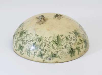 China lid, circa 1850. It is dome shaped and decorated with green vine leaves and grapes. An interest in nature and a widespread scientific interest in horticulture and botany made floral arrangements an important part of 19th Century decoration.