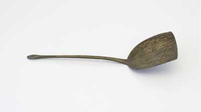 19th Century brass spatula spoon used for stirring on the stovetop and scraping food out of bowls and pots. It was donated by Mrs G Treacher in 2002.
