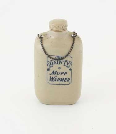 Victorian ladies's muff warmer. This small earthenware bottle would be filled with hot water and slipped into the muff, a fur tube used by ladies to protect their hands from the cold. Men wore fur or wool mittens covered with leather.
