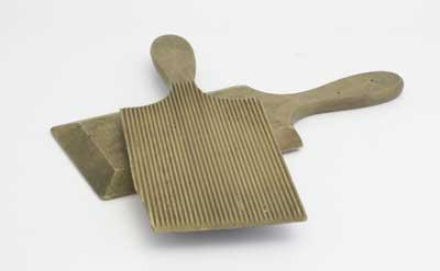 In the 19th Century butter pats were used to prepare butter ready for sale. The butter maker would use one of these thin tools in each hand and shape the butter into bricks. The inside of the pats was serrated to grip the butter and squeze out water. 