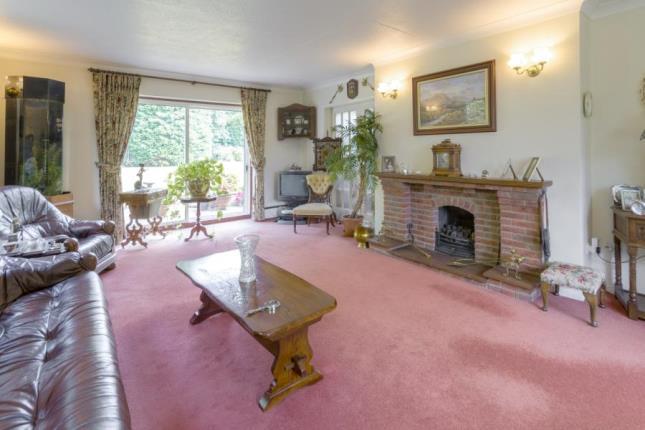 The living room is centered around a brick fire place. Photo: Taylors