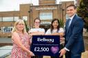 Good neighbours: Rafoella and Sallinda, left, from the charity receive a cheque from Bellway