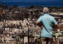 A man views the aftermath of a wildfire in Lahaina, Hawaii (Jae C Hong/AP, File)