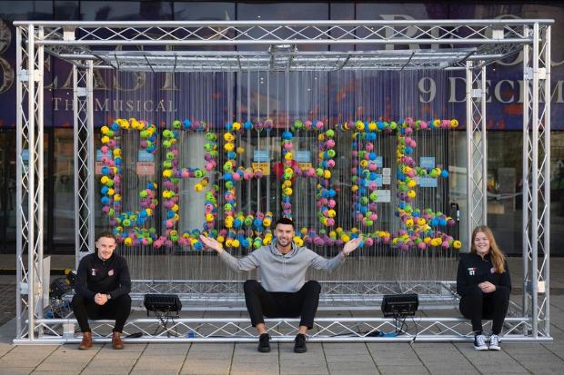 Hillingdon Times: Members of Street Football Wales with National Lottery ball display