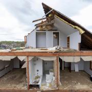 A partially torn off roof is seen on a damaged home in Omaha, Nebraska (Chris Machian/Omaha World-Herald via AP)